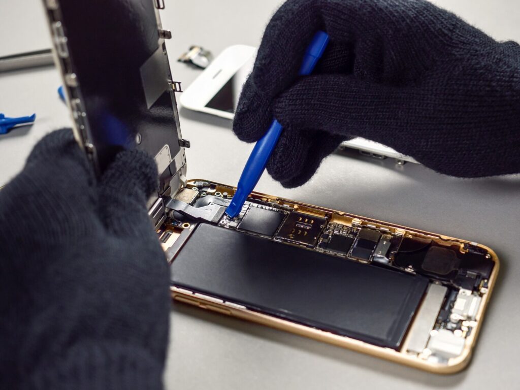 technician repairing broken smartphone desk 77206 88