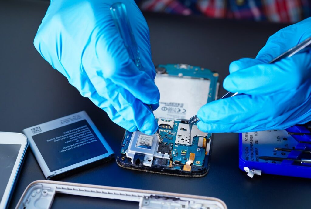 technician repairing inside mobile phone by soldering iron 39768 1947 technician repairing inside mobile phone by soldering iron 39768 1947