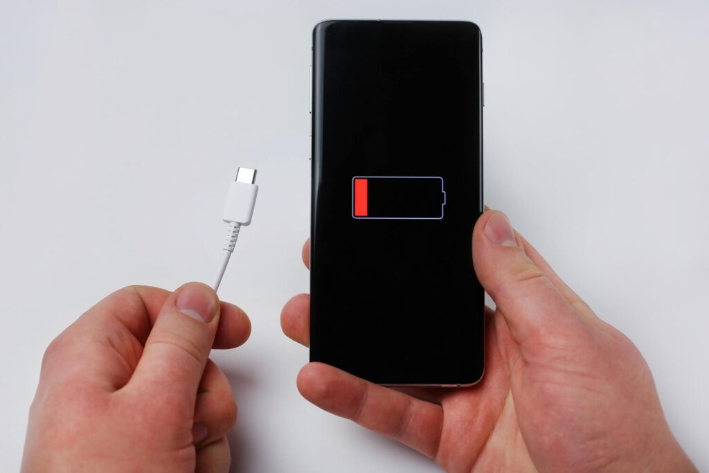 holds charging cable smartphone showing low battery 625925 429 holds charging cable smartphone showing low battery 625925 429