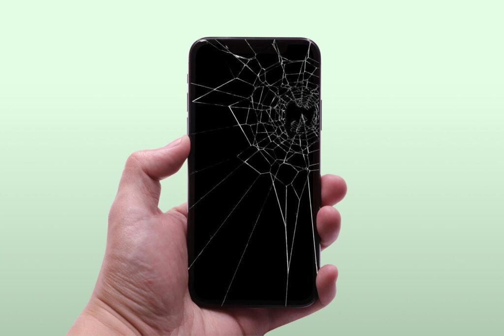 hand holding broken phone screen protector 03 984100 1176 hand holding broken phone screen protector 03 984100 1176