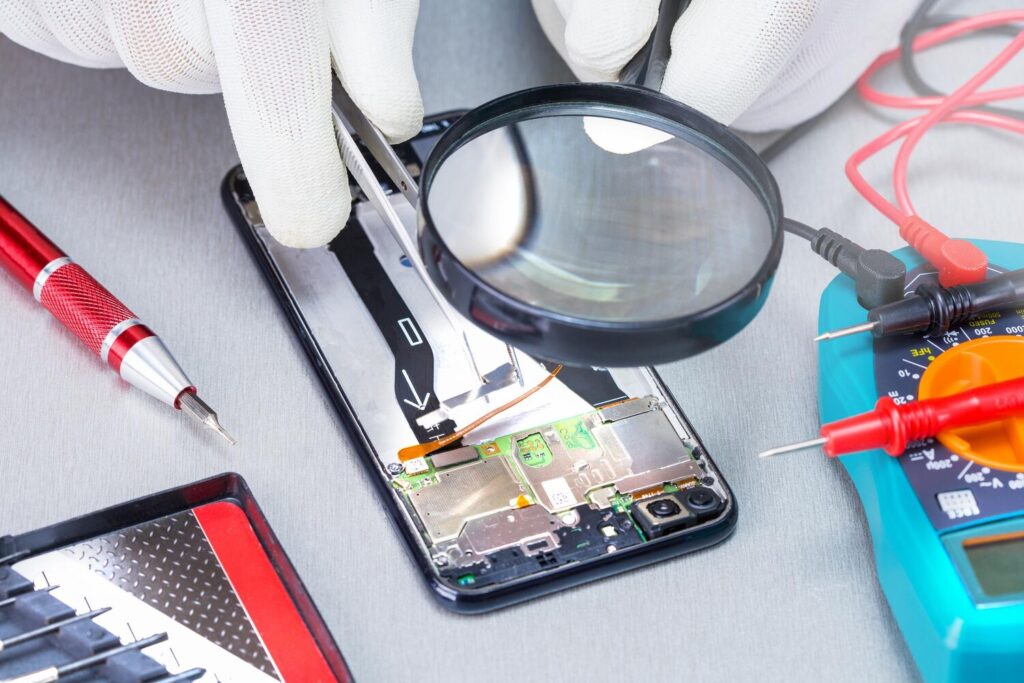 technician repairing inside mobile phone desk process mobile phone repair 106035 1485